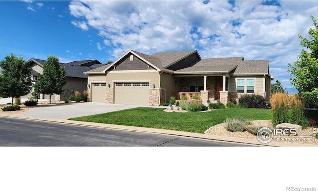 craftsman house with a garage, covered porch, and a front lawn