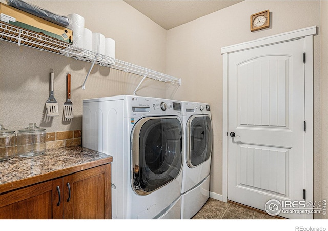 laundry room featuring tile patterned flooring and washer and clothes dryer