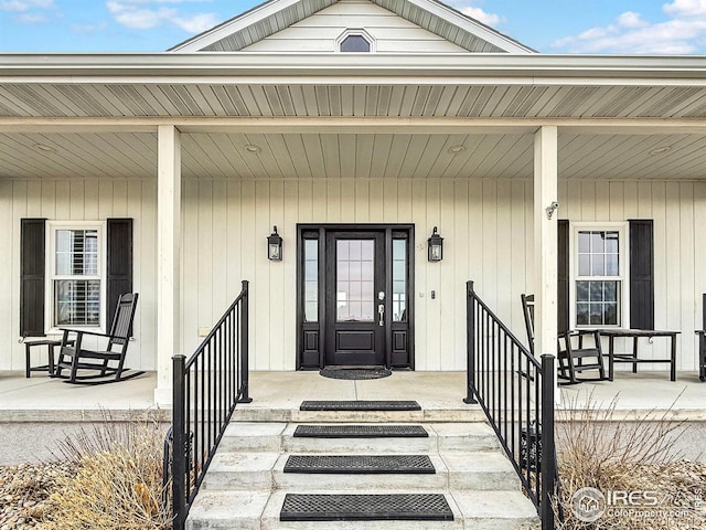 view of exterior entry featuring a porch