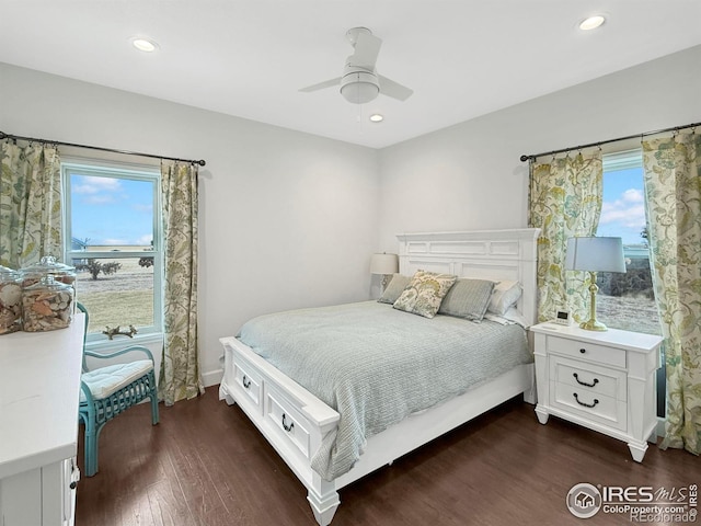 bedroom with dark wood-type flooring, ceiling fan, and multiple windows