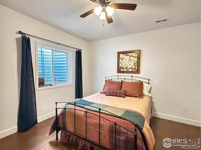 bedroom featuring dark wood-type flooring and ceiling fan