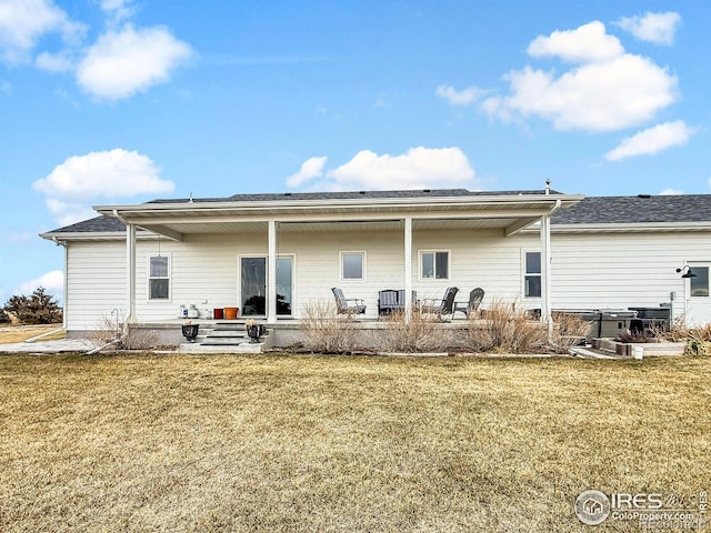 back of property featuring a yard and a patio