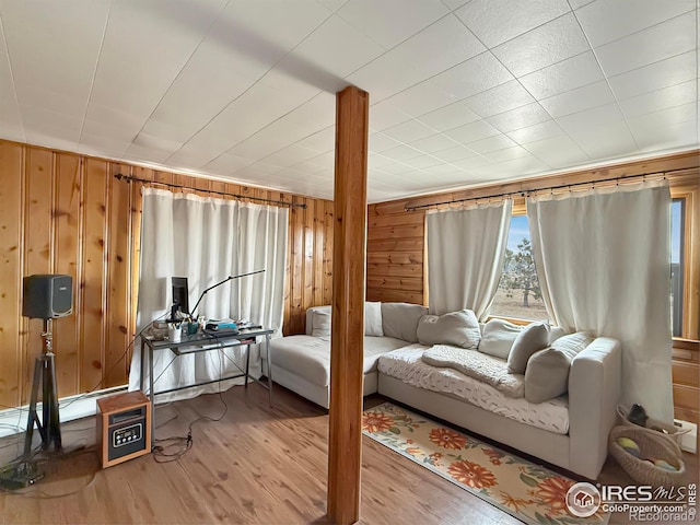 living room with wooden walls and light hardwood / wood-style floors