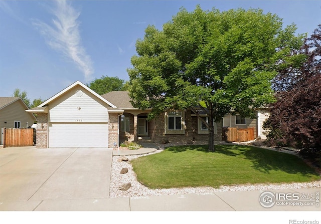 view of front of property with a garage and a front lawn