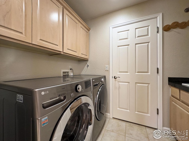 laundry room featuring cabinets, separate washer and dryer, and light tile patterned floors