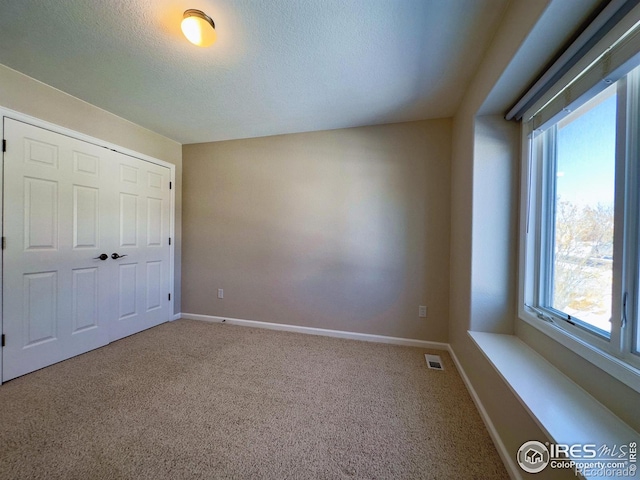 unfurnished bedroom featuring a closet and carpet