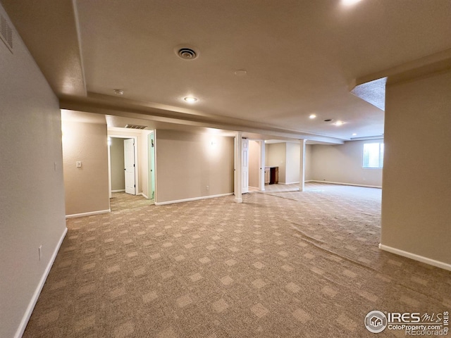 basement featuring light colored carpet