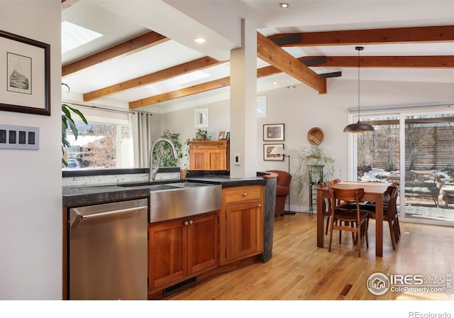 kitchen with sink, dishwasher, vaulted ceiling with beams, decorative light fixtures, and light wood-type flooring