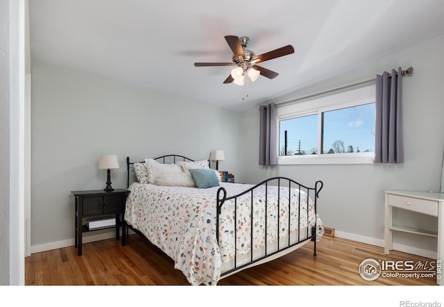 bedroom with hardwood / wood-style flooring and ceiling fan