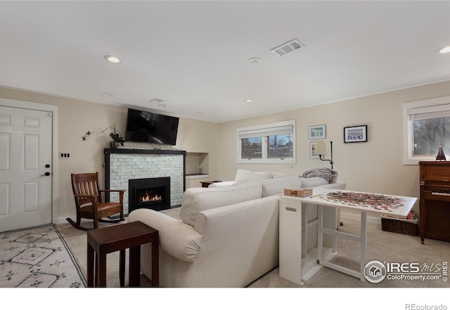 living room with a brick fireplace