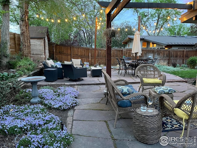 view of patio / terrace with an outdoor hangout area and a storage shed