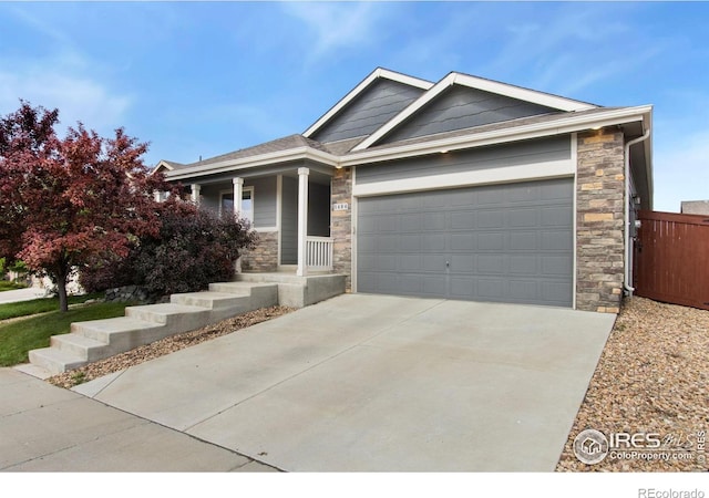 1484 First Light Dr, Windsor, CO 80550 - single story home with stone siding, covered porch, an attached garage, and concrete driveway