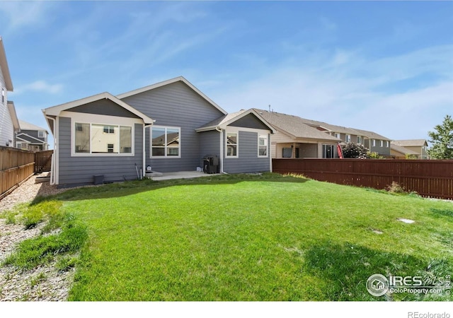 1484 First Light Dr, Windsor, CO 80550 - rear view of house with a fenced backyard and a patio