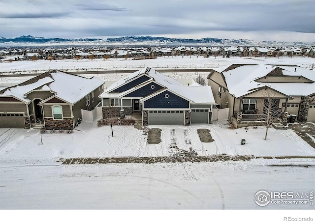 snowy aerial view with a mountain view