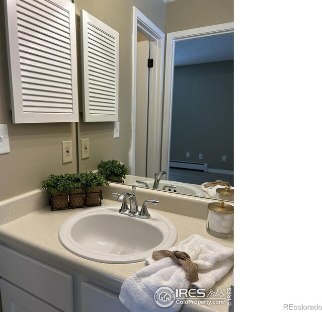 bathroom featuring vanity and baseboard heating