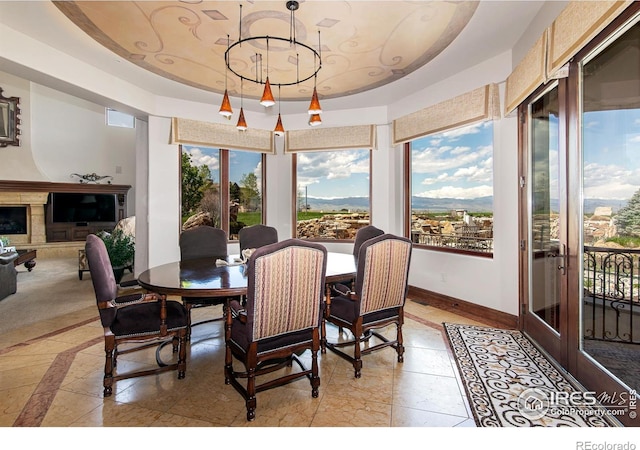 dining space featuring a mountain view and a tray ceiling