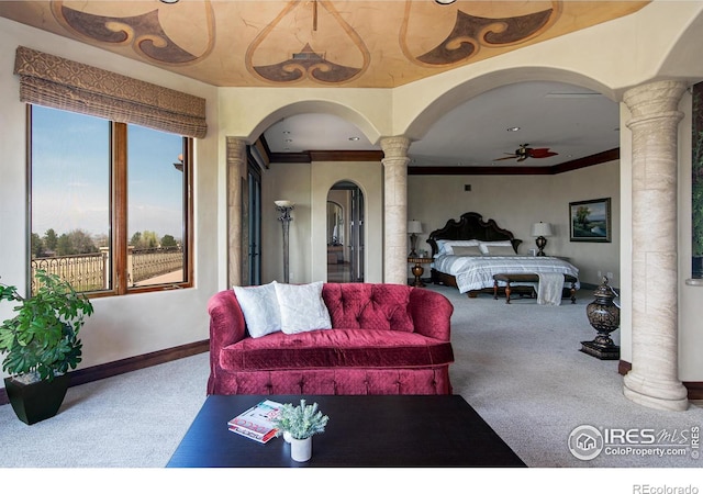 carpeted bedroom featuring ornamental molding and ornate columns