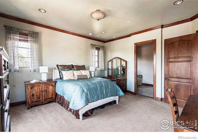 carpeted bedroom featuring ensuite bath and ornamental molding