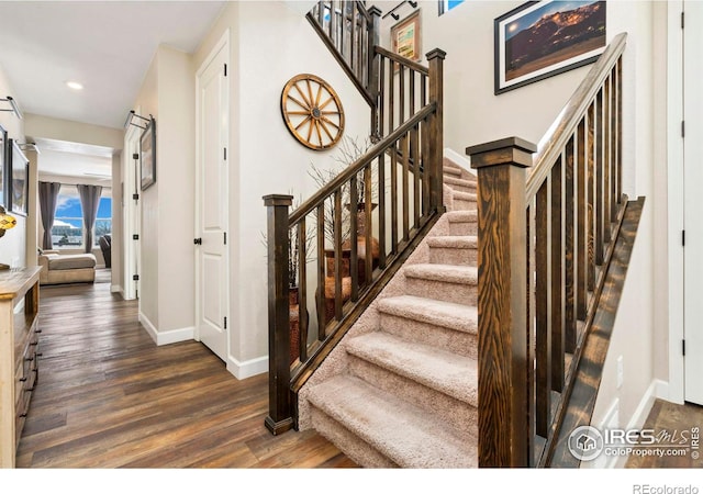 stairway featuring hardwood / wood-style floors