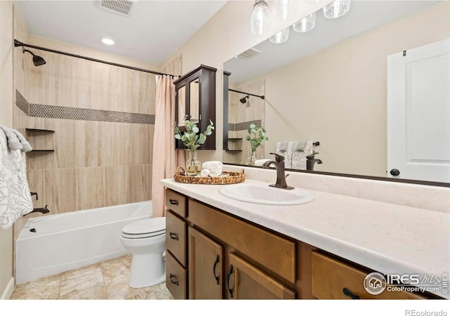 full bathroom with vanity, shower / tub combo, and toilet