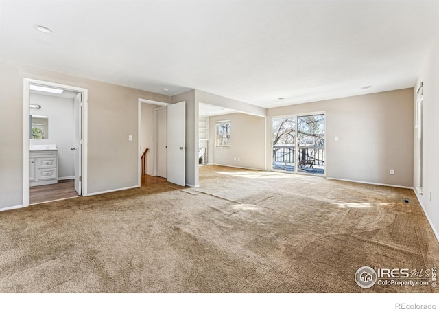 unfurnished living room featuring carpet