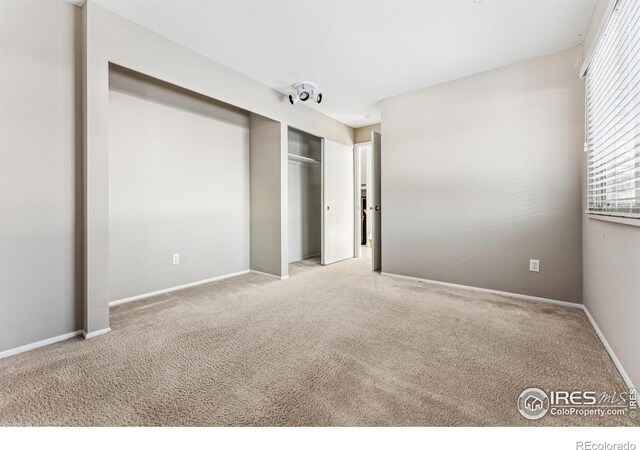 unfurnished bedroom featuring light colored carpet