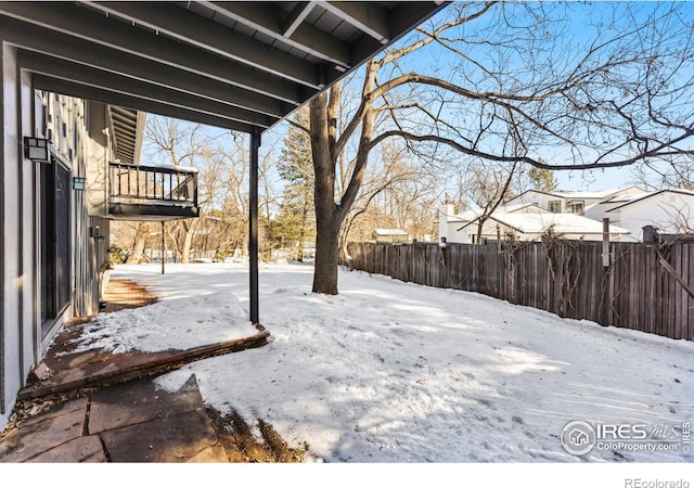 view of yard layered in snow