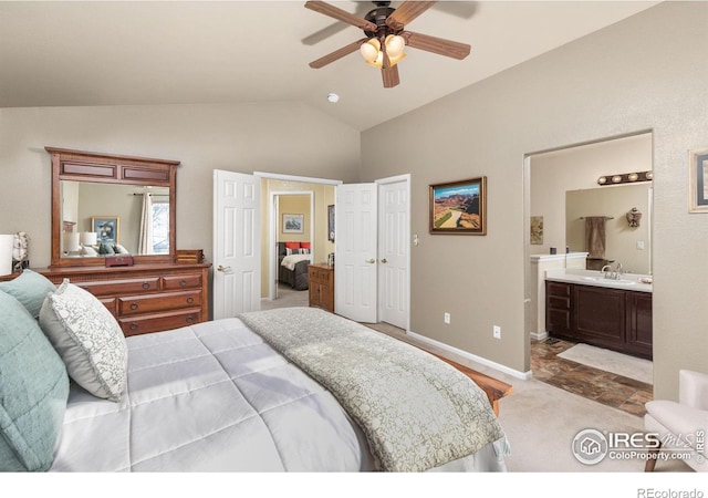 carpeted bedroom with lofted ceiling, sink, ensuite bath, and ceiling fan