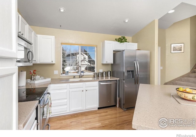 kitchen with sink, stainless steel appliances, and white cabinets