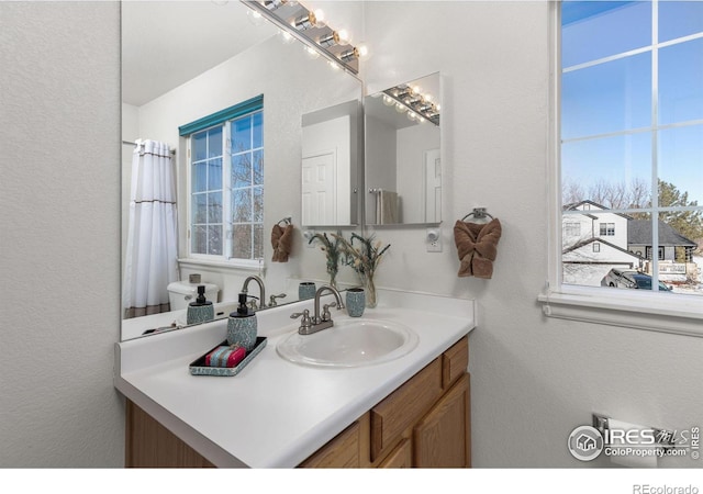 bathroom with vanity and a healthy amount of sunlight