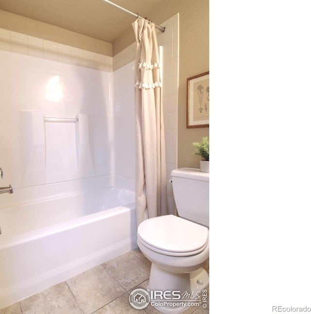 bathroom featuring shower / tub combo and toilet