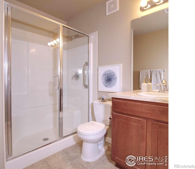 bathroom featuring vanity, an enclosed shower, tile patterned floors, and toilet