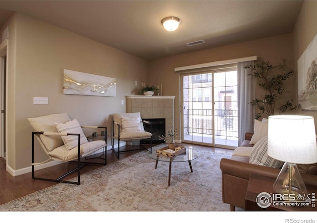 living room with a fireplace and light hardwood / wood-style flooring