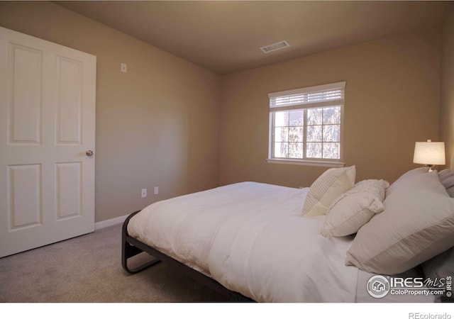 bedroom with light colored carpet