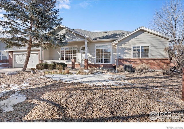 ranch-style house featuring a garage and covered porch