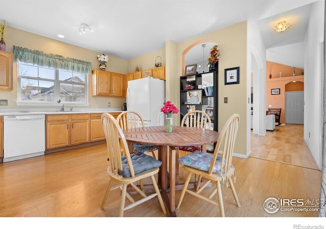 dining area featuring sink and light hardwood / wood-style floors