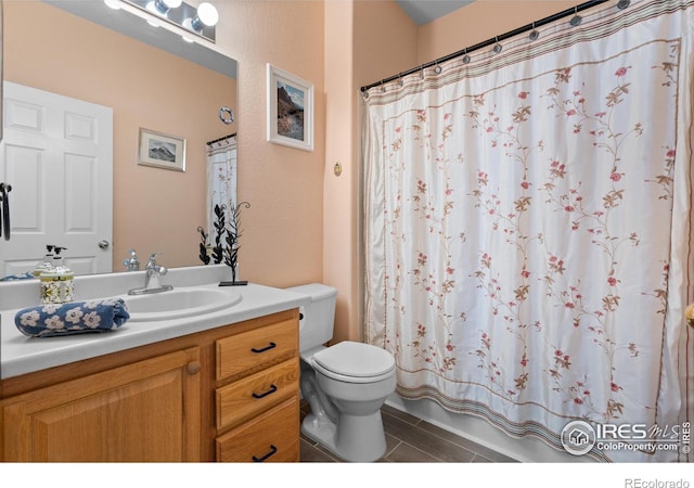 full bathroom with vanity, toilet, and shower / bath combo with shower curtain