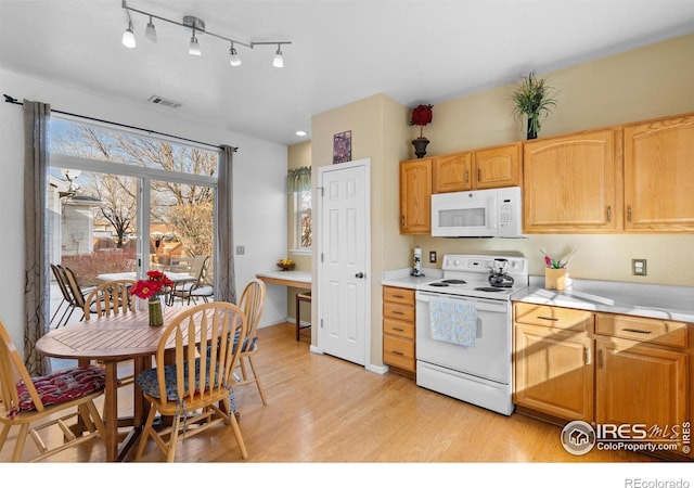 kitchen with white appliances and light wood-type flooring