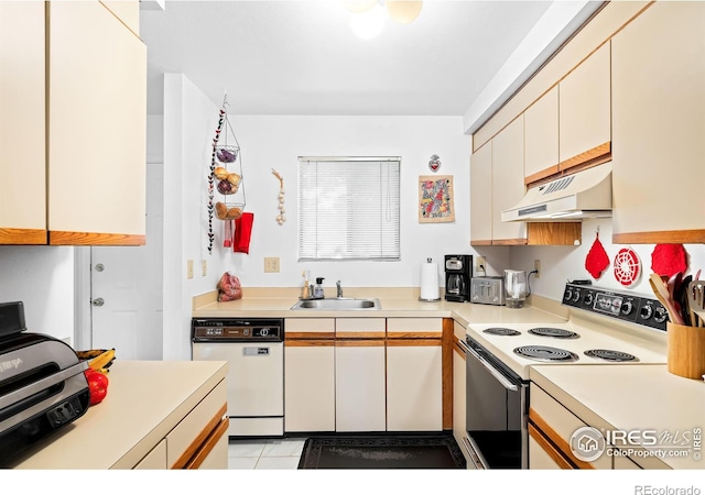 kitchen featuring sink, light tile patterned floors, and white appliances