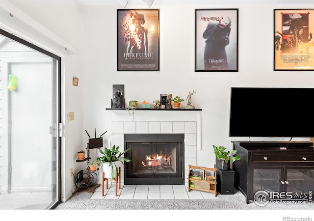 living room featuring a tile fireplace