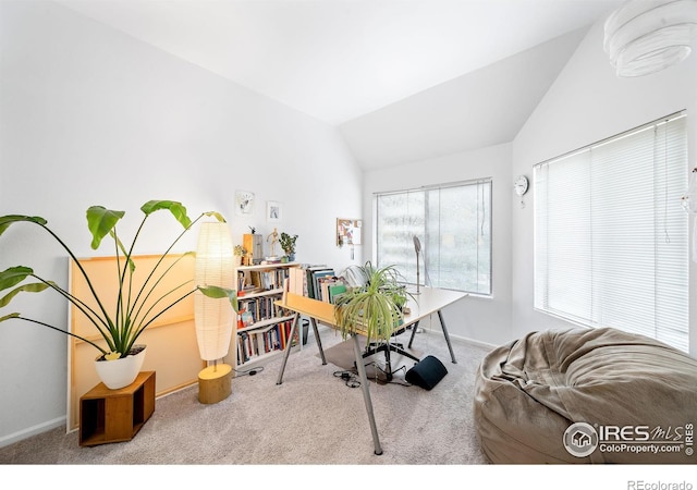 carpeted office featuring vaulted ceiling