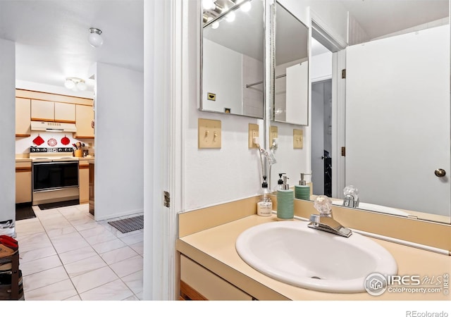 bathroom featuring tile patterned flooring and vanity