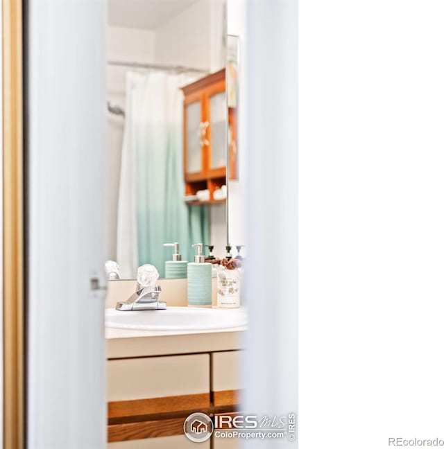 bathroom with vanity and a shower with shower curtain