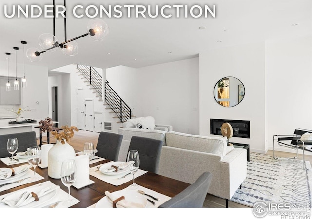 dining area with wood-type flooring and a chandelier