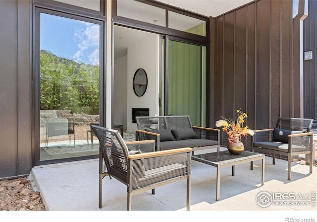 view of patio / terrace with an outdoor living space with a fireplace