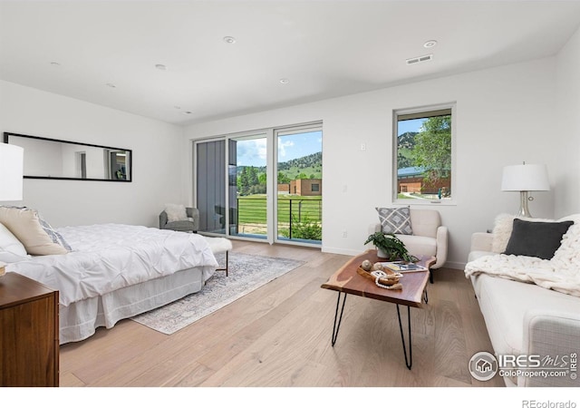 bedroom featuring light hardwood / wood-style floors and access to outside