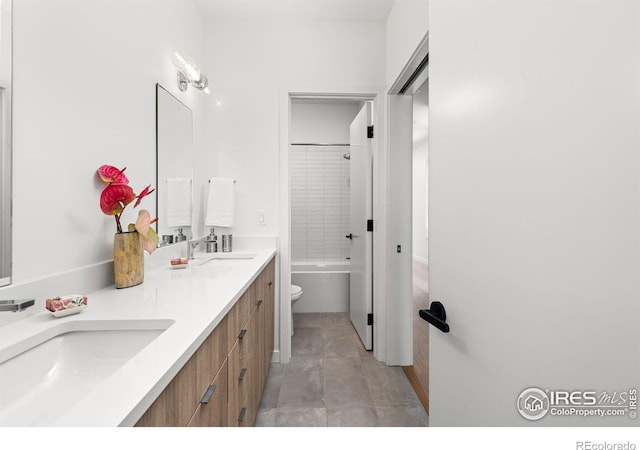 full bathroom with  shower combination, vanity, and toilet