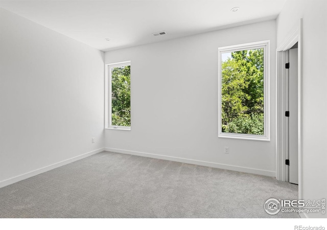 unfurnished room with light colored carpet