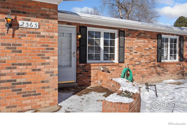 view of snow covered property entrance