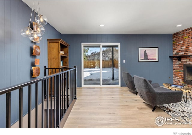 interior space featuring a brick fireplace and light wood-style flooring